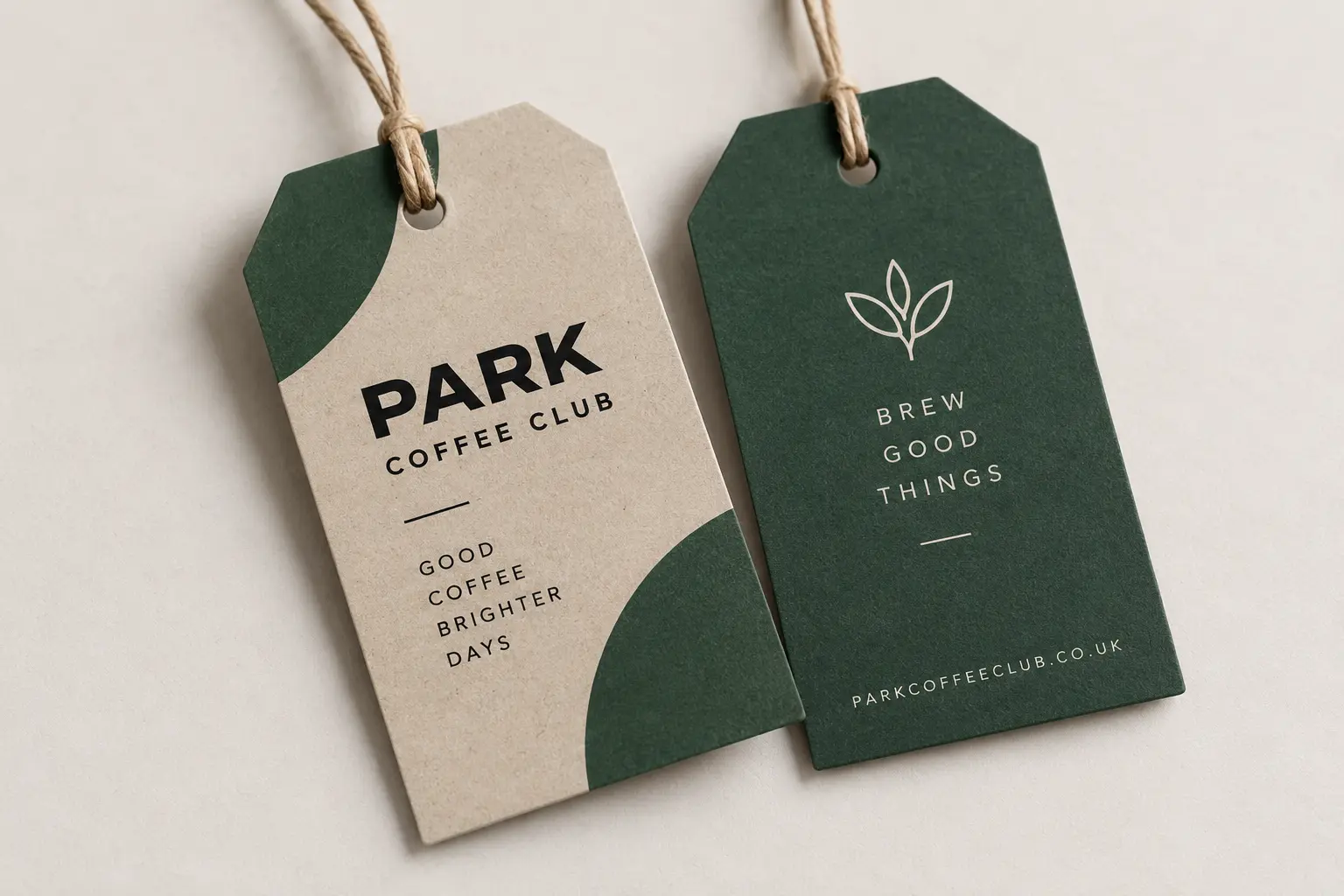 Two custom-printed kraft and dark green swing tags with twine